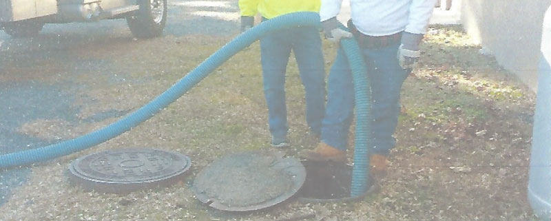 John's Septic crew pumping a tank on site